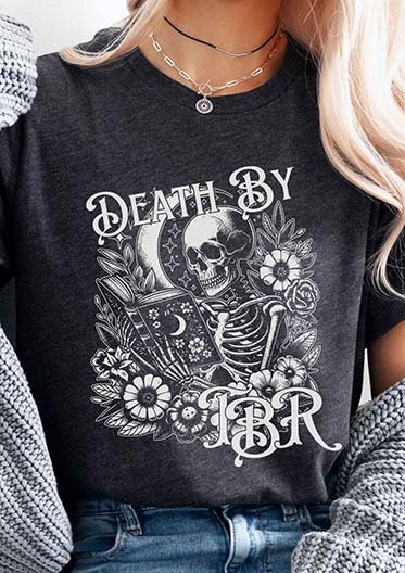 image of a woman wearing a t-shirt with the text Death by TBR and a graphic of a skeleton reading a book and surrounded by flowers - the readers nook